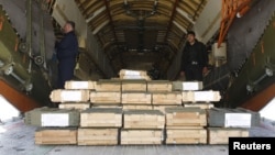 Boxes of ammunition are seen inside a Russian aircraft at the International Kabul Airport, Afghanistan, Feb. 24, 2016. Afghan officials took delivery of 10,000 automatic rifles and millions of rounds of ammunition as a gift from Russia.