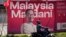 A motorist passes by a giant election poster of Malaysian Prime Minister Anwar Ibrahim ahead of the state election in Kuala Lumpur, Malaysia Aug. 9, 2023. Six of Malaysia’s 13 states are holding elections Saturday.