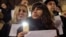 Romanian magistrates stand holding copies of their professional oath during a silent protest outside the Bucharest Court of Appeal in Bucharest, Romania, Dec. 18, 2017. 