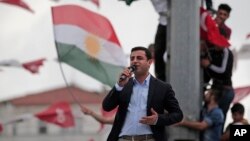 Ahead of Sunday's election, Selahattin Demirtas, head of the pro-Kurdish Peoples' Democratic Party (HDP), delivers a speech from the top of his election campaign bus at a rally in Istanbul, Turkey, June 6, 2015.