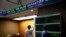 Two men check an index board at the reception hall of the Athens' Stock Exchange, in Athens, Aug. 4, 2015. 
