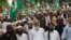 FILE - Sunni cleric Maulana Ahmed Ludhianvi, center, leader of Ahl-e-Sunnat Wal Jamaat (ASWJ), a political and religious group, leads a protest rally in Islamabad, Aug. 22, 2014.