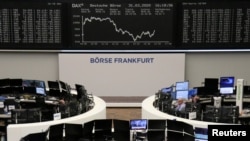 FILE - The German share price index DAX graph is pictured at the stock exchange in Frankfurt, Germany, March 31, 2020. 