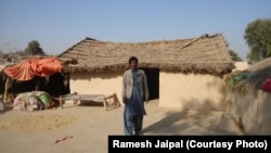 Ramesh Jaipal stands outside his family's home in Rahim Yar Khan, Pakistan.