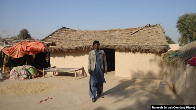 Ramesh Jaipal stands outside his family's home in Rahim Yar Khan, Pakistan.