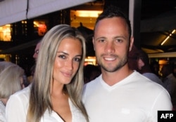 FILE - Olympian sprinter Oscar Pistorius posing next to his girlfriend Reeva Steenkamp at Melrose Arch in Johannesburg, Jan. 26, 2013.