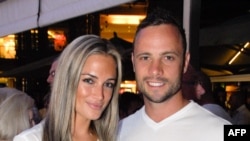 Olympian Oscar Pistorius poses with girlfriend Reeva Steenkamp in Johannesburg, Jan. 26, 2013, less than a month before her death.