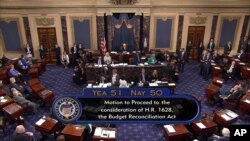 FILE - This image from video provided by C-SPAN2 shows the final Senate vote, with Vice President Mike Pence's vote, to start debate to tear down much of the Obama health care law, July 25, 2017, on the floor of the Senate on Capitol Hill in Washington.