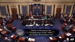 Image from video provided by C-SPAN2 shows the final Senate vote, with Vice President Mike Pence's vote, to start debate to tear down much of the Obama health care law, July 25, 2017, on the floor of the Senate on Capitol Hill in Washington.