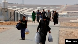 Refugiados sirios recién llegados caminan hacia el campo Azraq area, al este de Amman, donde ya viven 10,498 refugiados.