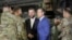 (FILE) U.S. Defense Secretary Pete Hegseth and Polish Defence Minister Wladyslaw Kosiniak-Kamysz meet U.S. soldiers as they visit airbase in Powidz, Poland February 15, 2025.