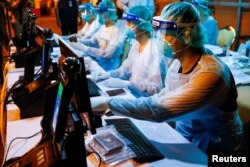 Immigration officers wearing protective suits prepare immigration for Thai nationals evacuated from China's Wuhan province, the center of the coronavirus epidemic, at the U-Tapao airport in Rayong province, Thailand, Feb. 4, 2020.