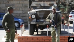 FILE - Army personnel man outside the military headquarters in Maseru, Lesotho, Aug. 31, 2014.