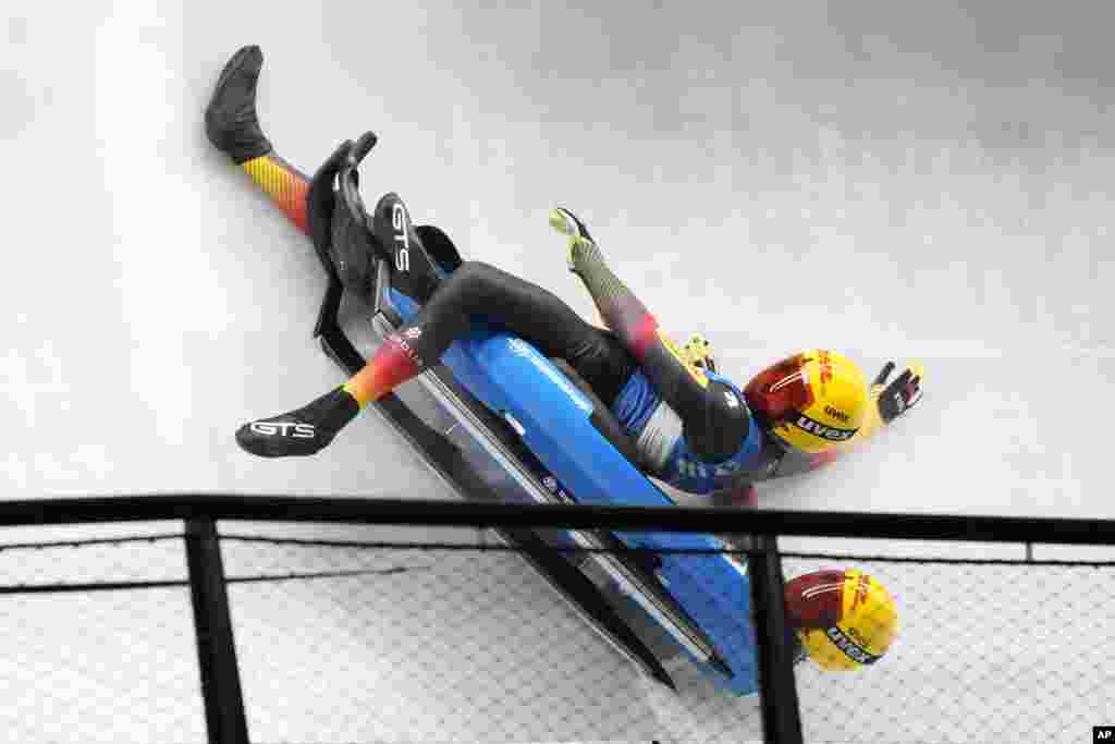 Toni Eggert and Sascha Benecken of Germany lose their sled while competing in the relay race at the Luge World Cup, a test event for the 2022 Winter Olympics, at the Yanqing National Sliding Center in Beijing, China.