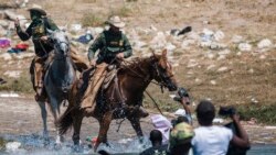 FILE - U.S. Customs and Border Protection mounted officers attempt to contain migrants as they cross the Rio Grande from Ciudad Acuña, Mexico, into Del Rio, Texas, Sept. 19, 2021.