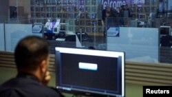 UK Border Force officers work in the Watch Room overlooking Immigration Control as Britain's Prime Minister Theresa May visits the UK Border Force Command Centre at Terminal 5 London Heathrow Airport in west London, Britain, Dec. 19, 2018.