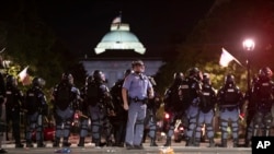 Raleigh Police block Fayetteville Street at Hargett Street as they work to return order after a night of violent demonstrations, May 31, 2020, in Raleigh, North Carolina. (Credit: Robert Willett/The News & Observer)