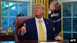 US President Donald Trump gestures as he speaks after announcing and initial deal with China.