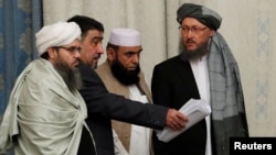 FILE - Members of Taliban delegation take their seats during the multilateral peace talks on Afghanistan in Moscow, Nov. 9, 2018.