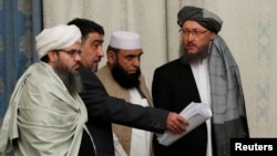 FILE - Members of Taliban delegation take their seats during the multilateral peace talks on Afghanistan in Moscow, Nov. 9, 2018.