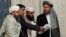 FILE - Members of a Taliban delegation take their seats during peace talks on Afghanistan in Moscow, Russia, Nov. 9, 2018.