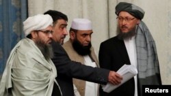 FILE - Members of Taliban delegation take their seats during the multilateral peace talks on Afghanistan in Moscow, Nov. 9, 2018.