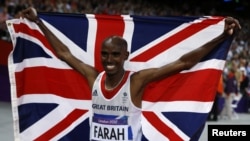Britain's Mo Farah holds the Union Flag after winning the men's 10,000m final at the London 2012 Olympic Games at the Olympic Stadium August 4, 2012.