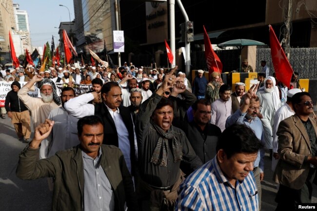 Journalists and social activists chant slogans during a rally protest which they say is against layoffs and the non-payment of salaries, in Karachi, Pakistan Feb. 8, 2019.