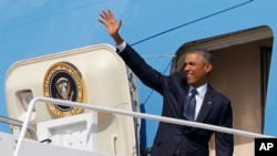 President Barack Obama waves as he boards Air Force One at Andrews Air Force Base, Md., Sept. 2, 2014, as he begins his trip to Estonia and Wales for the NATO Summit.