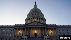 FILE - Lights shine from the U.S. Capitol dome in Washington, Dec. 18, 2019.