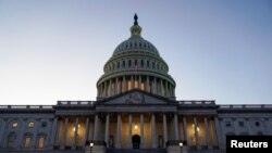 FILE - Lights shine from the U.S. Capitol dome in Washington, Dec. 18, 2019.