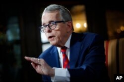 FILE - Ohio Governor Mike DeWine speaks during an interview at the Governor's Residence in Columbus, Ohio, Dec. 13, 2019.
