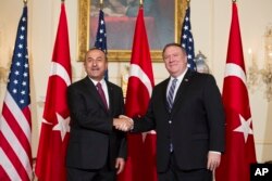 Secretary of State Mike Pompeo, right, meets with Turkish Foreign Minister Mevlut Cavusoglu at the State Department in Washington, June 4, 2018.