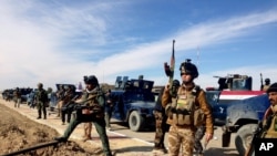 FILE - Iraqi security forces prepare to attack al-Qaida positions in Ramadi, 115 kilometers (70 miles) west of Baghdad, Iraq, Feb. 2, 2014.