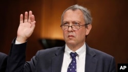 FILE - Thomas Farr is sworn in during a Senate Judiciary Committee hearing on his nomination to be a District Judge on the United States District Court for the Eastern District of North Carolina, Sept. 20, 2017.