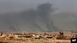 Smoke rises after an airstrike by U.S.-led coalition warplanes during fighting on the western side of Mosul, Iraq, Feb. 27. 2017. A senior Iraqi police commander said Monday that troops have taken control of the western side of a key bridge in Mosu.