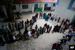 Maldivians queue at a polling station during presidential election day in Male, Sept. 23, 2018.