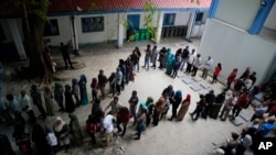 Maldivians queue at a polling station during presidential election day in Male, Sept. 23, 2018. 