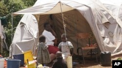 A mother with three children outside their tent in an internally displaced persons camp in the Kenyan town of Naivasha (File Photo)