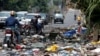 FILE - Motorcyclists look at military uniforms from the Armed Forces of the Democratic Republic of Congo lying on the ground, amid clashes between them and the M23 rebels, in Goma, eastern DRC, Jan. 30, 2025.