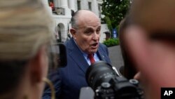 FILE - President Donald Trump's lawyer Rudy Giuliani speaks to reporters on the South Lawn of the White House in Washington, May 30, 2018.