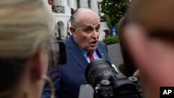 FILE - President Donald Trump's lawyer Rudy Giuliani speaks to reporters on the South Lawn of the White House in Washington, May 30, 2018.