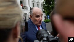 FILE - President Donald Trump's lawyer Rudy Giuliani speaks to reporters on the South Lawn of the White House in Washington, May 30, 2018.