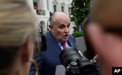 FILE - President Donald Trump's lawyer Rudy Giuliani speaks to reporters on the South Lawn of the White House in Washington, May 30, 2018.