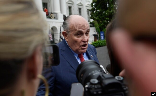 FILE - President Donald Trump's lawyer Rudy Giuliani speaks to reporters on the South Lawn of the White House in Washington, May 30, 2018.