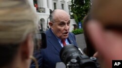 FILE - President Donald Trump's lawyer, Rudy Giuliani, speaks to reporters on the South Lawn of the White House in Washington, May 30, 2018.