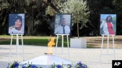 The portraits of, from left, victims Nadine Devillers, Vincent Loques and Brazil's Simone Barreto Silva are pictured during a ceremony in Nice, France, November 7, 2020.