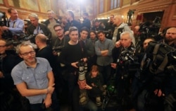FILE - Journalists wait for the start of a news conference by Hungarian Prime Minister Viktor Orban and Russian President Vladimir Putin, in Budapest, Hungary, Feb. 2, 2017.
