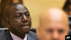 Kenya's Deputy President William Ruto, left, awaits start of trial, courtroom of the International Criminal Court, The Hague, Netherlands, Sept. 10, 2013.