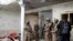 Pejuang Taliban memeriksa sebuah rumah setelah terjadi baku tembak selama delapan jam antara Taliban dan kelompok ISIS, saat pasukan Taliban menyerbu tempat persembunyian militan ISIS di pinggiran Jalalabad, timur Kabul, Afghanistan, Selasa, 30 November 2021.